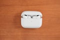 Air Pods Pro. with Wireless Charging Case. New Airpods pro on wooden background. Airpods. Copy space