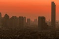 Air pollution in Bangkok, Thailand. Smog and fine dust of pm2.5 covered city in the morning with orange sunrise sky. Cityscape