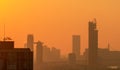 Air pollution in Bangkok, Thailand. Smog and fine dust of pm2.5 covered city in the morning with orange sunrise sky. Cityscape