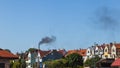 Air pollution, black smoke from chimney over urban area