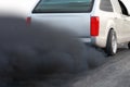 Air pollution crisis in city from diesel vehicle exhaust pipe on road