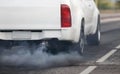 Air pollution from diesel vehicle exhaust pipe on road