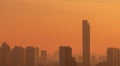 Air pollution. Smog and fine dust of pm2.5 covered city in the morning with orange sunrise sky. Cityscape with polluted air. Dirty