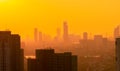 Air pollution. Smog and fine dust of pm2.5 covered city in the morning with orange sunrise sky. Cityscape with polluted air. Dirty