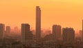 Air pollution. Smog and fine dust of pm2.5 covered city in the morning with orange sunrise sky. Cityscape with polluted air. Dirty