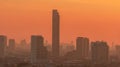 Air pollution. Smog and fine dust of pm2.5 covered city in the morning with orange sunrise sky. Cityscape with polluted air. Dirty