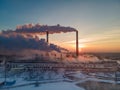 Air pollution by smoke coming out of the factory chimneys in the industrial zone Royalty Free Stock Photo