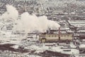 Air pollution by smoke coming out of two factory chimneys. Industrial zone in the city. Royalty Free Stock Photo