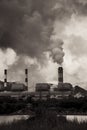 Air pollution smoke from factory chimneys dark scary sky vertical shot Royalty Free Stock Photo