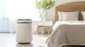 Air purifier in cozy white bedroom for filter and cleaning removing dust PM2.5 HEPA and virus in home,for fresh air and healthy Royalty Free Stock Photo