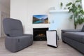 Air purifier in cozy white living room for filter and cleaning removing dust PM2.5 HEPA and virus in home, for fresh air