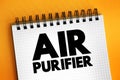 Air Purifier is a device which removes contaminants from the air in a room to improve indoor air quality, text concept on notepad