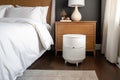 air purifier on nightstand, providing peaceful and healthy sleeping environment