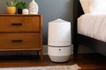 air purifier on nightstand, providing a peaceful sleep for its owner