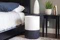 air purifier on nightstand, providing a peaceful sleep for its owner