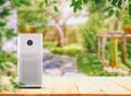 Air Purifier on the wood table at graden.  Air purification from viruses and bacteria Royalty Free Stock Photo