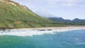 Air shot on Oahu Hawaii Island. Drone flies over Sandy Beach. View of the rocky mountains. Warm sunny day on a tropical Royalty Free Stock Photo