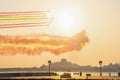Air show with seven jet planes flying over presidential palace in Abu Dhabi paint the sky with flag colour in sunset