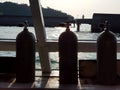 Air tanks in the slots for SCUBA divers on the boat, silhouette Royalty Free Stock Photo