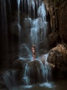 Woman standing on rock. Waterfall water flowing. Royalty Free Stock Photo