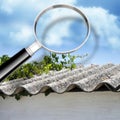 Air testing and monitoring activity around a dangerous asbestos roof - concept image with magnifying glass