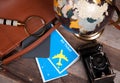 Air ticket, globe and bag on wood background Royalty Free Stock Photo