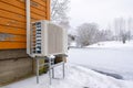 Air to water heat pump near an old wooden house in winter. air water heatpump close up