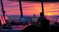Air Traffic Controller Sitting in Modern Control Tower During Sunset Royalty Free Stock Photo