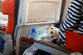 Air travel with children. Jorney with babies. Man is sitting in an airplane chair with a toy