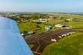 Air travel in Fiji, Melanesia, Oceania. View of hangars, helicopters and small planes on Nausori Suva International Airport apron.