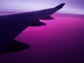 Air travel plane wing wih violet sky Royalty Free Stock Photo