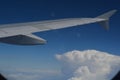 Air travel plane wing wish blue sky and clouds Royalty Free Stock Photo