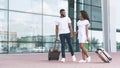 Air Travel Resumption. Black Couple Walking With Hand Luggage Suitcases Near Airport Royalty Free Stock Photo