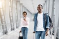 Air Travelling. Happy Smiling Black People Walking With Suitcases In Airport Terminal Royalty Free Stock Photo