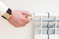 Air venting the radiator with a drain valve key. Release of trapped air in a heating radiator in an apartment.Bleed valve. Royalty Free Stock Photo