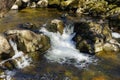 Aira Beck flows between shallow pools creating foaming waterfalls