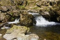 Aira Beck tumbles over rocks as it flows down through woodland