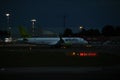 AirBaltic airline Airbus A220-300 aircraft on the runway of Riga International Airport at night. Riga International Airport,