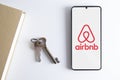 AirBNB app running on a smartphone next to home keys. Travel and accommodation concept with empty copy space