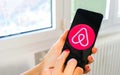 AirBnb travel app hand icon smartphone Royalty Free Stock Photo