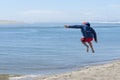 Airborne child after jumping off of sand dune Royalty Free Stock Photo