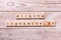 Airborne transmission word written on wood block. Airborne transmission text on wooden table for your desing, coronavirus concept