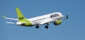 Airbus A220-300. Air Baltic Airlines flies in the blue sky Royalty Free Stock Photo