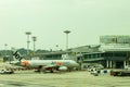 An Airbus A320 Airplane Of Jetstar Airways Connected To The Terminal Gate Via A Boarding Bridge In Changi Airport.