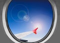 Airbus a380 airplane window during a sunny day above the clouds Royalty Free Stock Photo