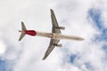 Airbus A321 of the Iberia airline seen with a low angle view just after take off in cloudy blue sky