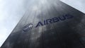 Airbus logo on a skyscraper facade reflecting clouds. Editorial 3D rendering