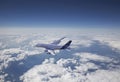 An Airbus A380 plane flies above the clouds