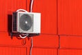 Airconditioning unit on a red wall Royalty Free Stock Photo