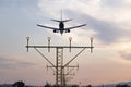 Aircraft during the approach procedure at sunset overflying the runway lights Royalty Free Stock Photo